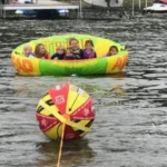 Au Pair and host kids tubing on the lake