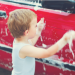 Toddler cleaning car