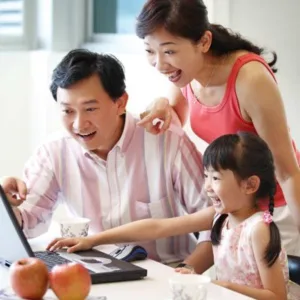 Family looking at computer together