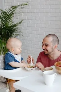 Dad feeding toddler