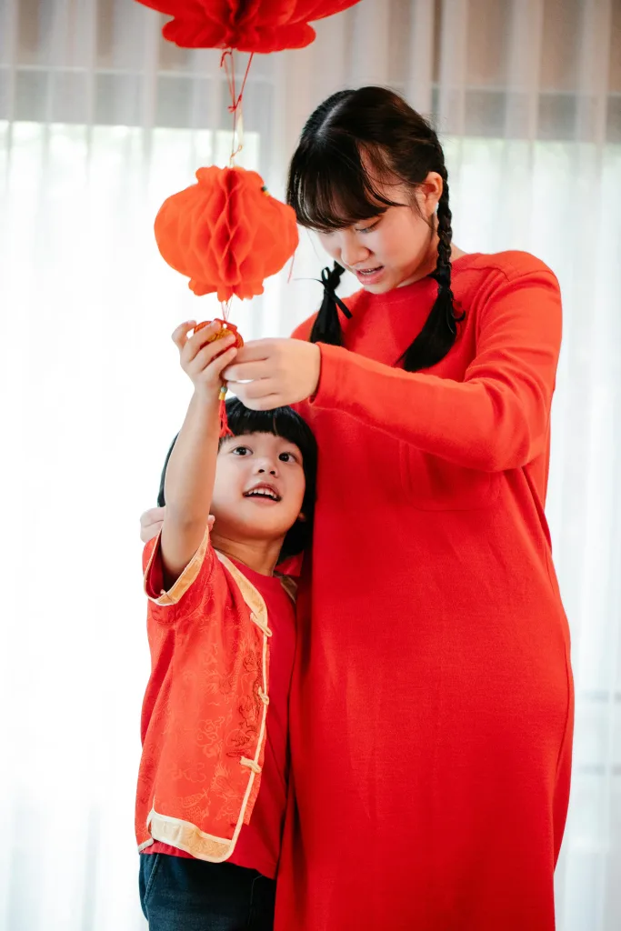 Au Pair and child wearing red for luck and prosperity