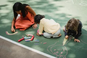 Children playing with sidewalk chalk