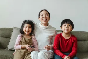 Au Pair and kids enjoying a movie together