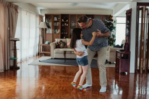 Dad showing young daughter how to dance