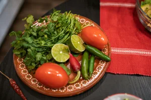 Traditional Mexican ingredients used in American cuisine: cilantro, tomatoes, lime, peppers