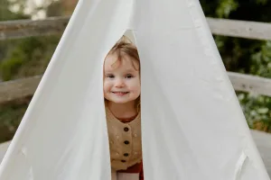 Child playing in a tent.