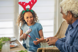 Child pulling a Christmas cracker