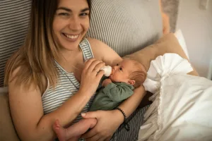 Au Pair feeding baby a bottle