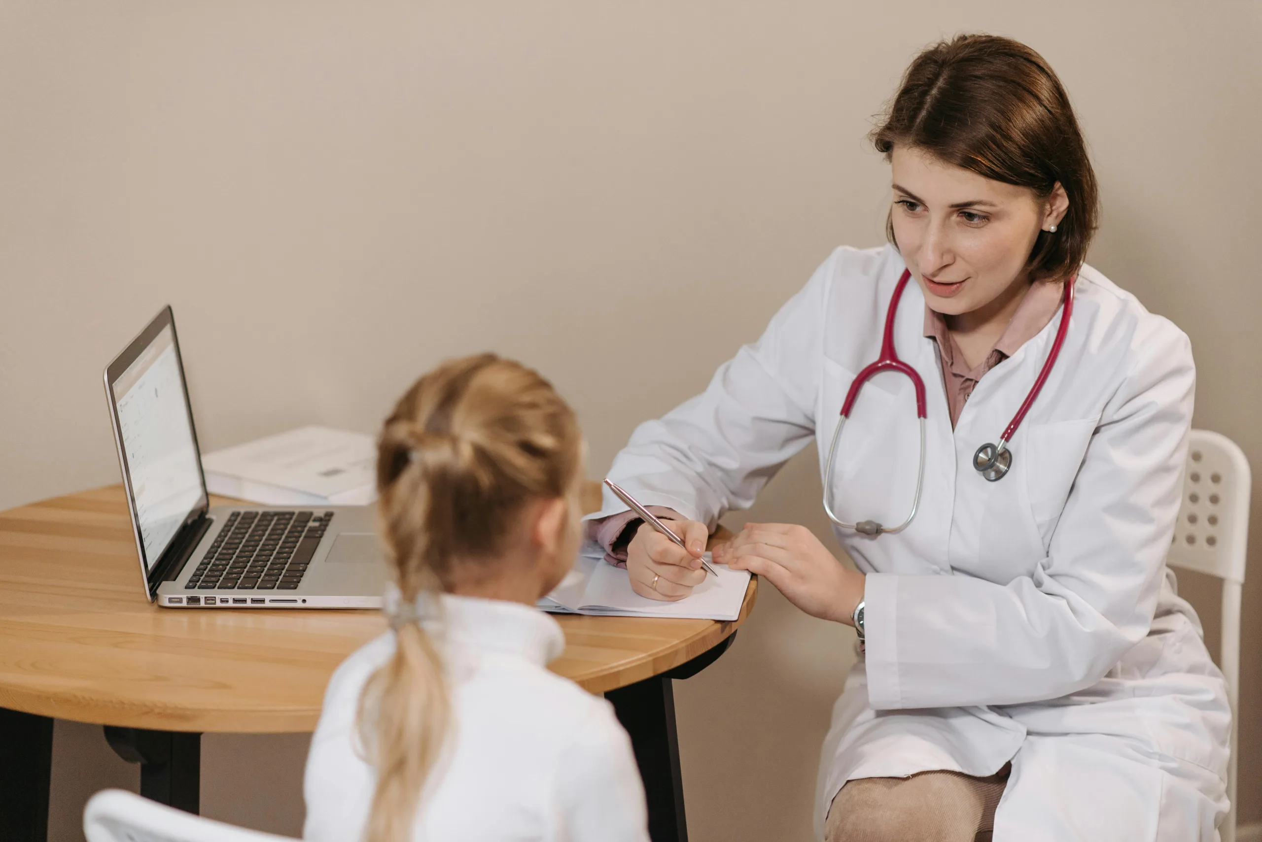 Pediatrician seeing a child at an appointment.