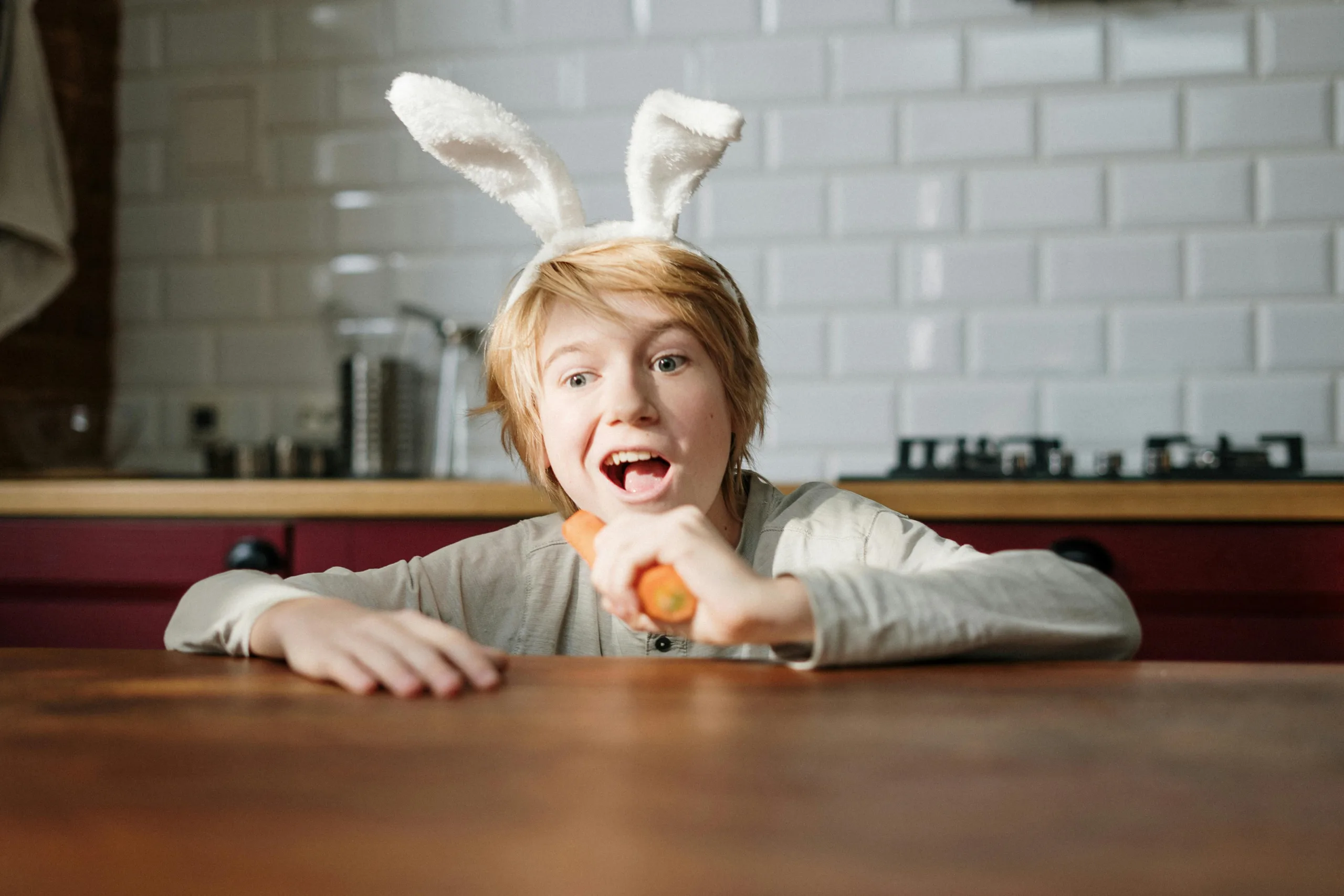 Child letting imaginations run wild by pretending to be a rabbit.