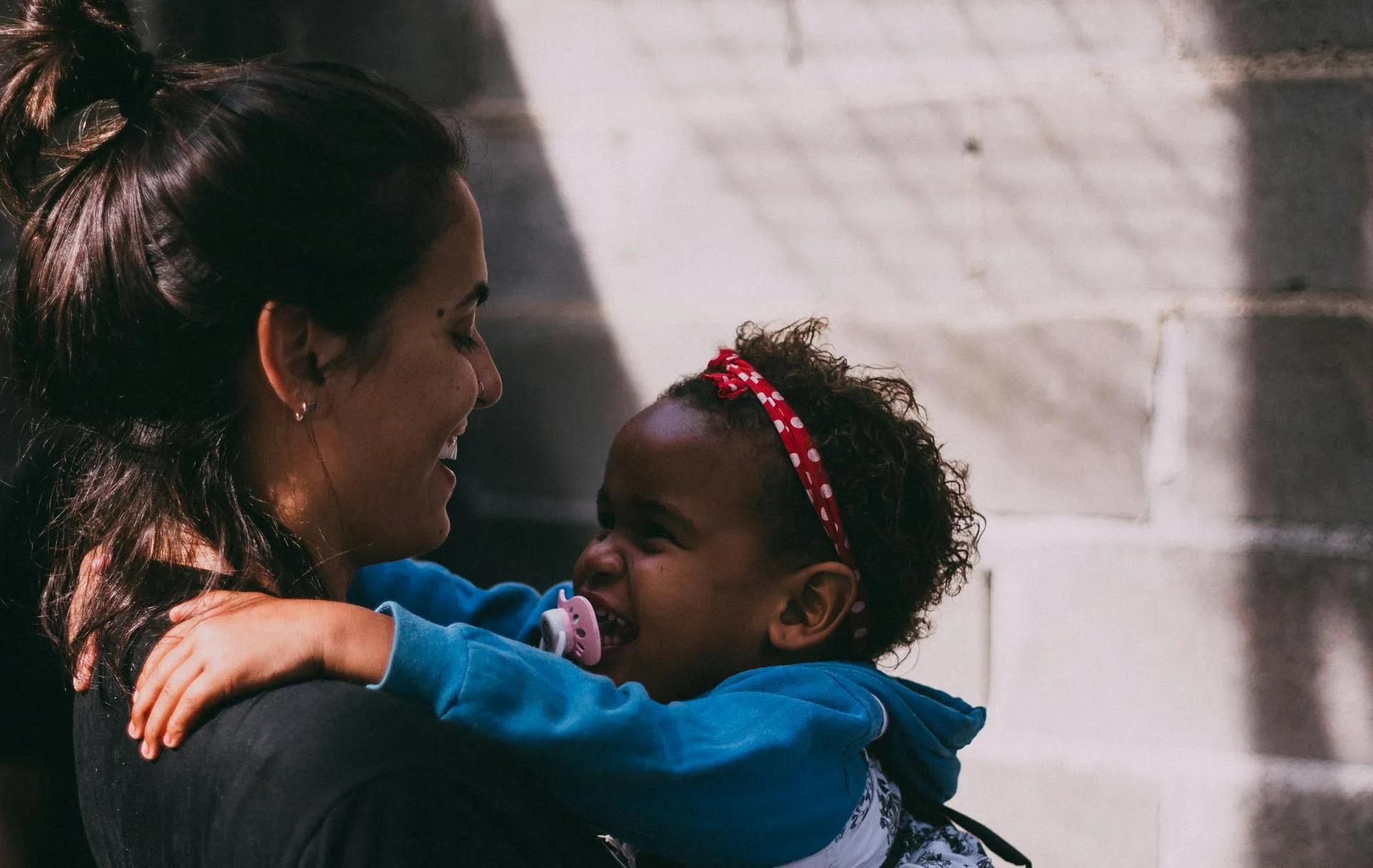 Brazilian Au Pair laughing with baby