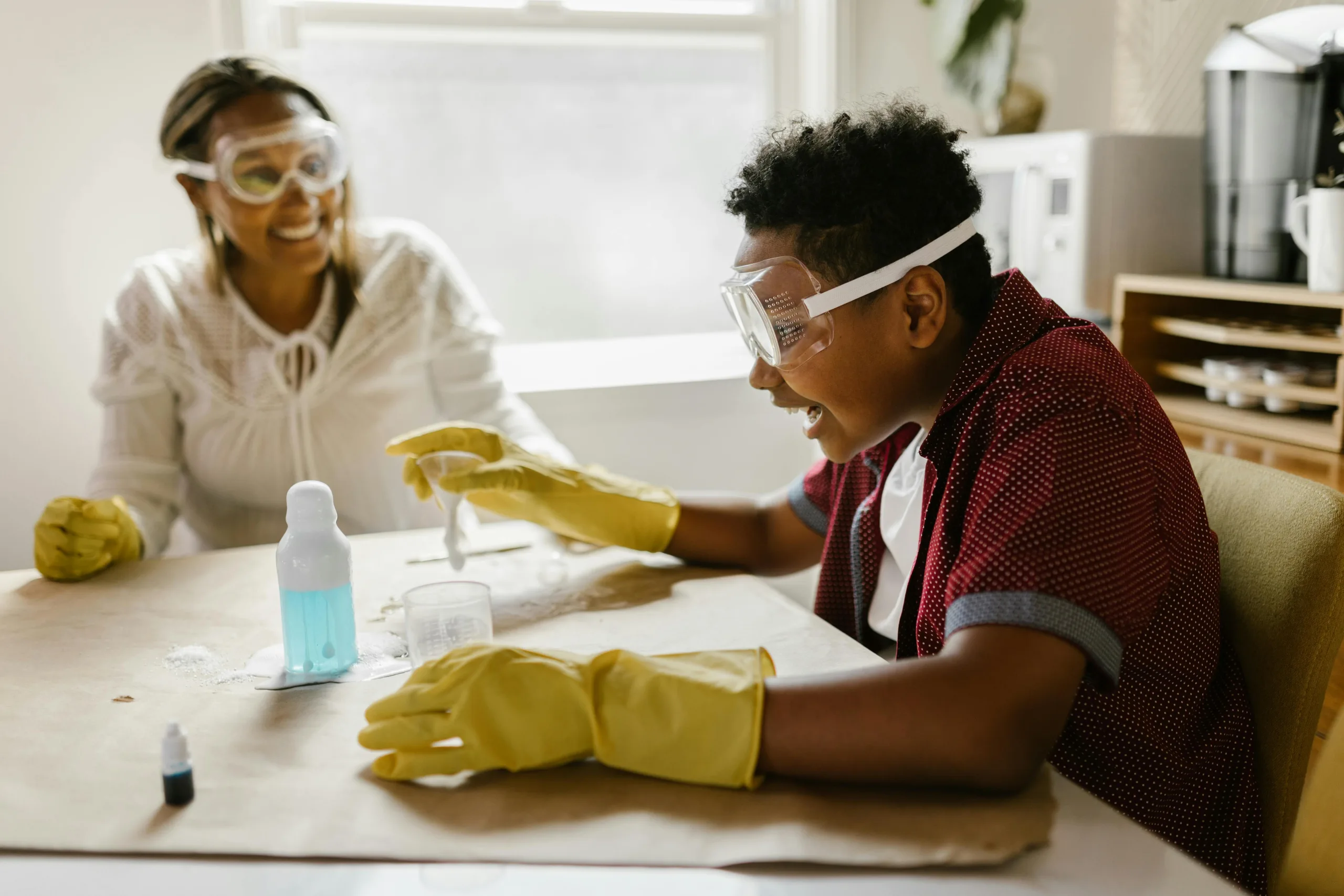 Brazilian Au Pair helping child with science experiment 