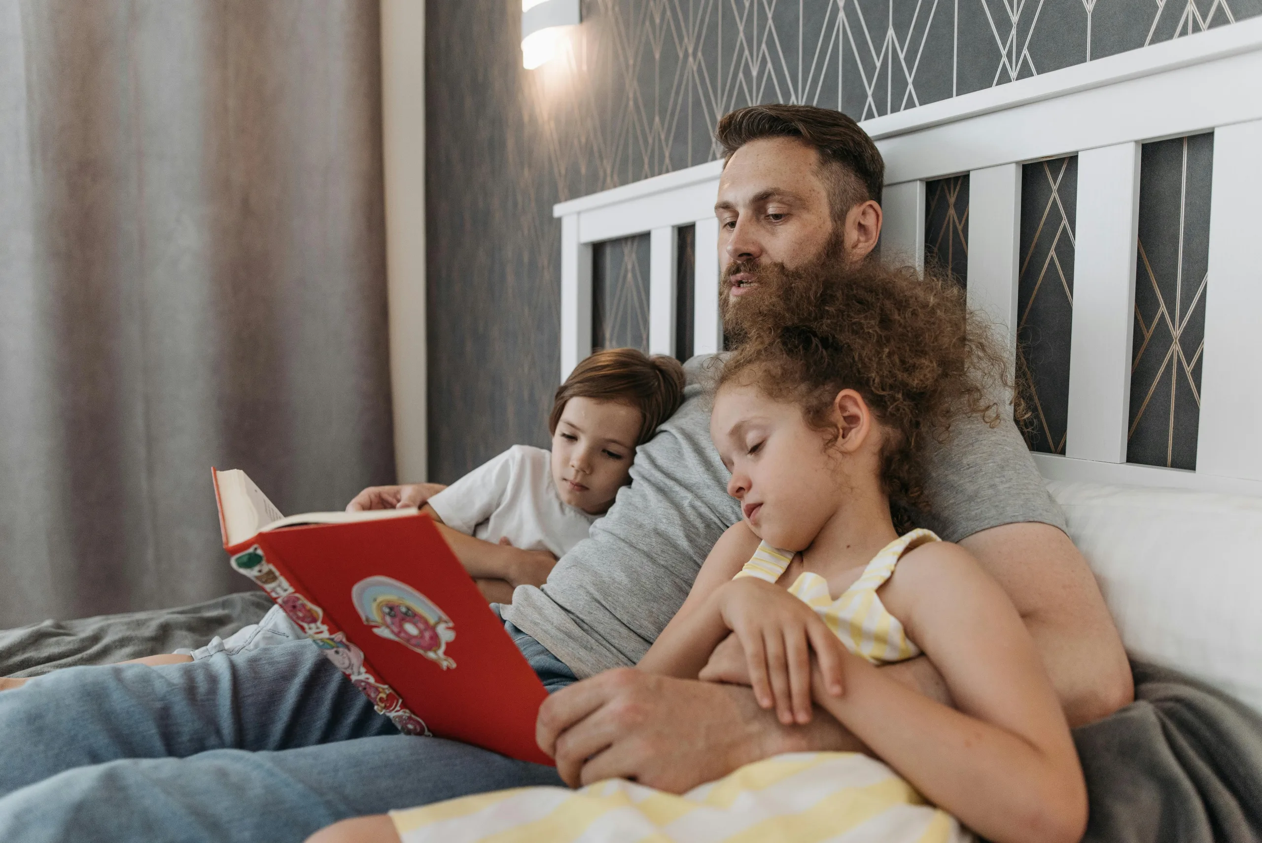 Dad reading to children before lights out.