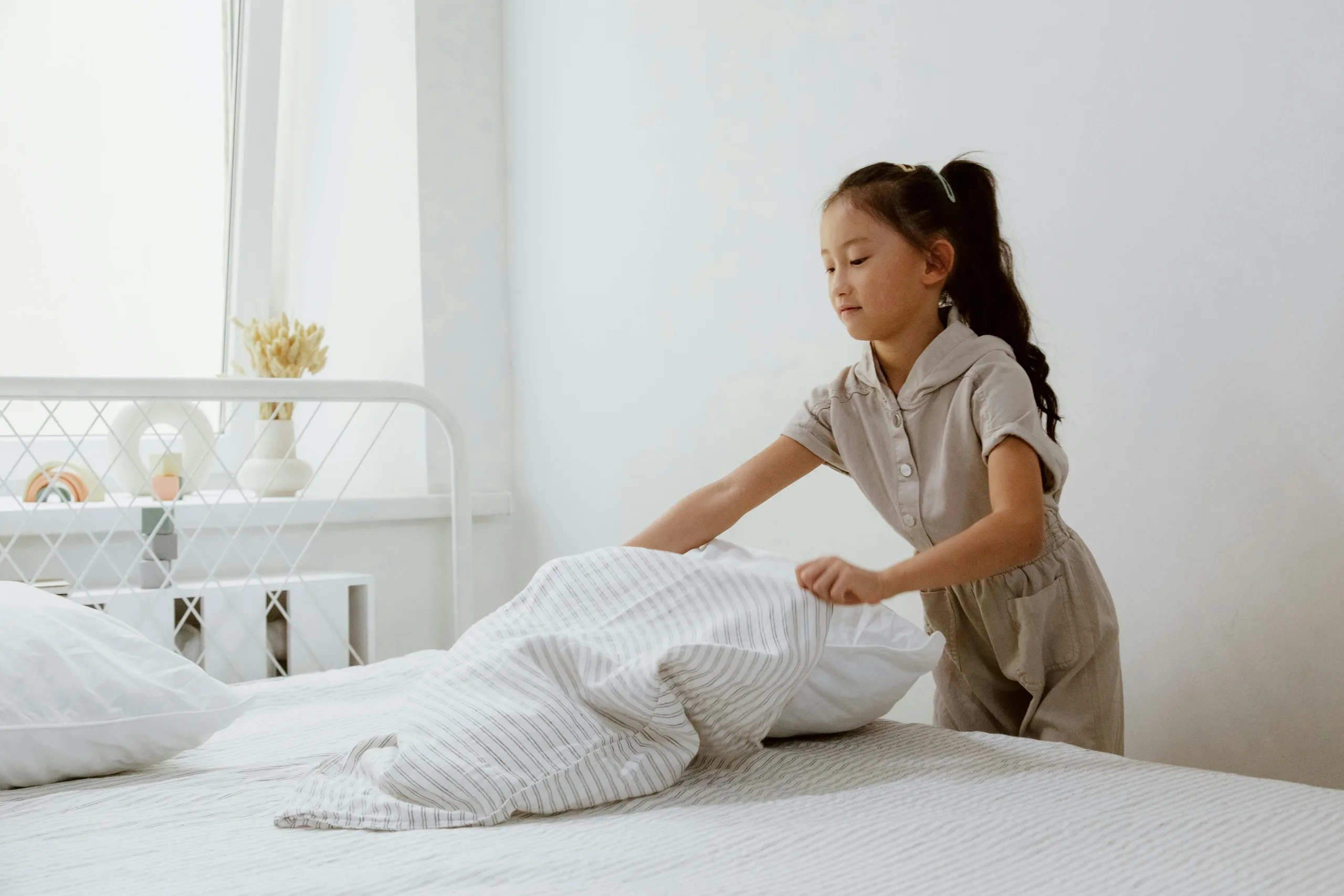 Child making bed