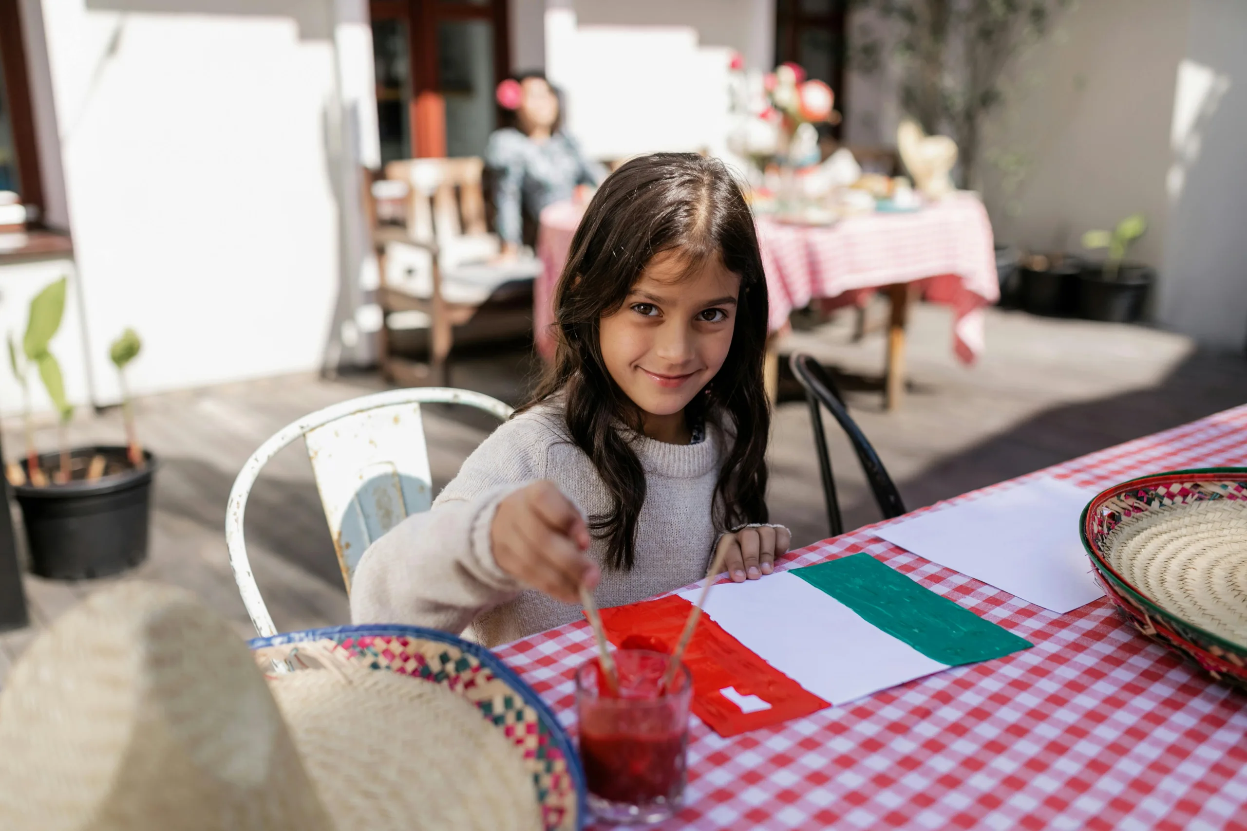 Child painting a Mexican flag