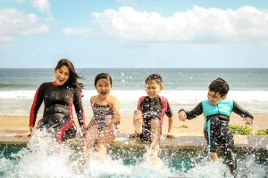 Au Pair and kids having fun at the beach